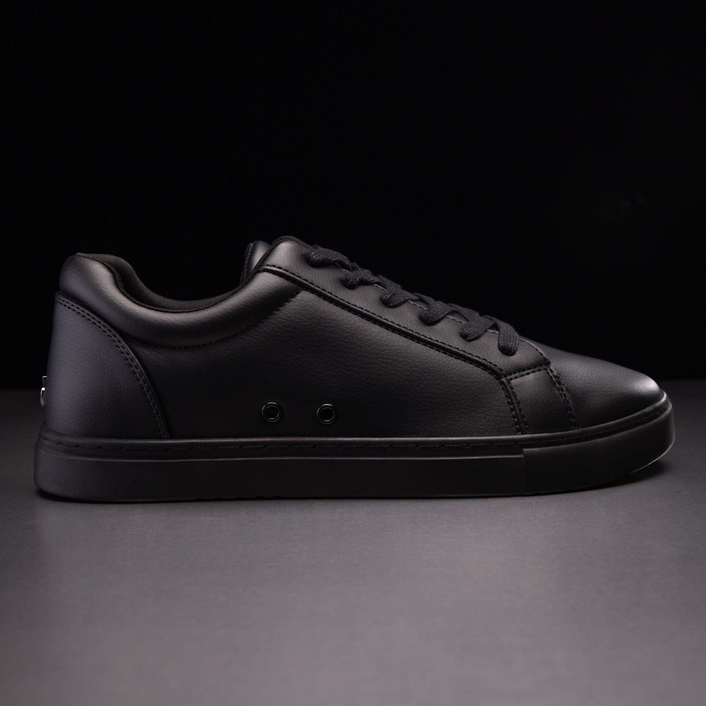 All black low store top sneakers